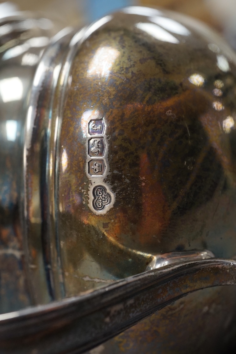 A George V silver two handled sugar bowl, by Goldsmiths & Silversmiths Co Ltd, Sheffield, 1923, with engraved initial, on four winged paw feet, length `7.1cm over handles, 8.5oz.